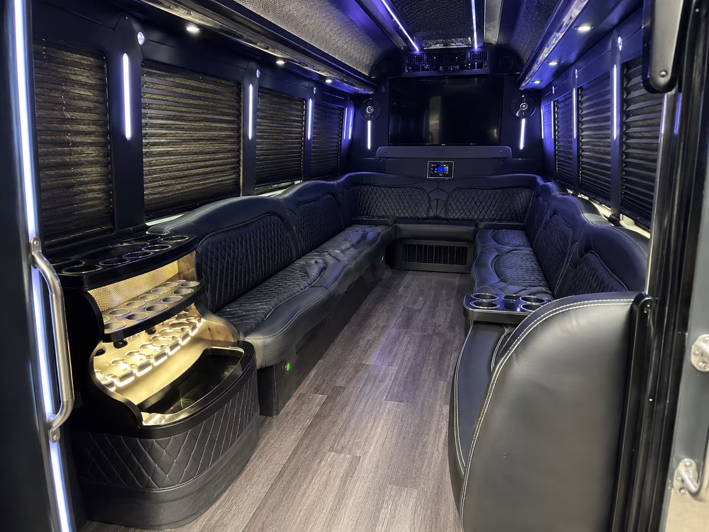 Friends laughing during a party bus celebration in Houston